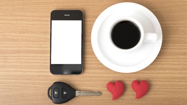 coffee phone car key and heart on wood table background