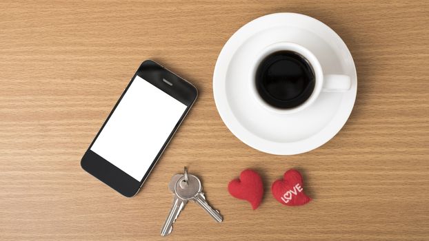 coffee phone key and heart on wood table background