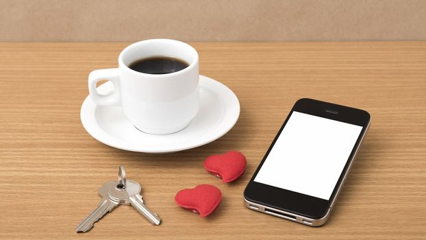 coffee phone key and heart on wood table background