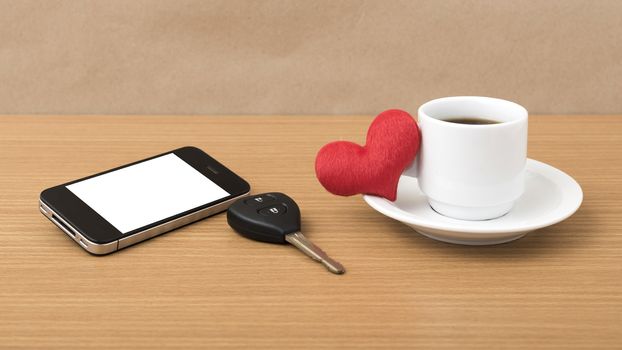 coffee phone car key and heart on wood table background