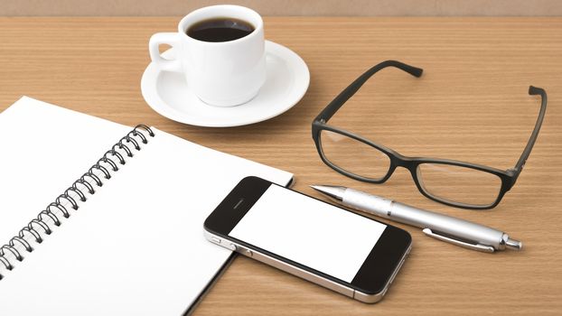 coffee,phone,notepad and eyeglasses on wood table background