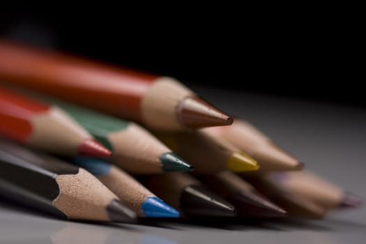 Group of colored pencils with shallow depth of field on black background