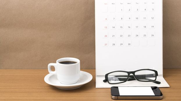 coffee,phone,eyeglasses and calendar on wood table background