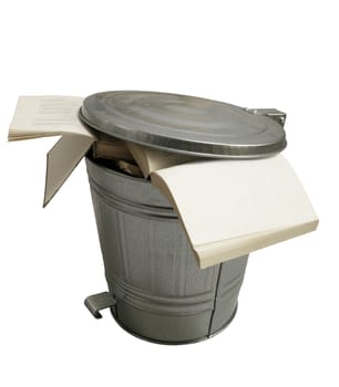 Open books thrown in a metallic trash can isolated on white background