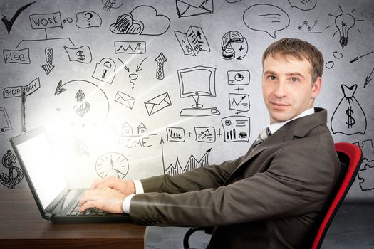 Businessman working on glowing laptop and looking at camera grey wall background with different symbols