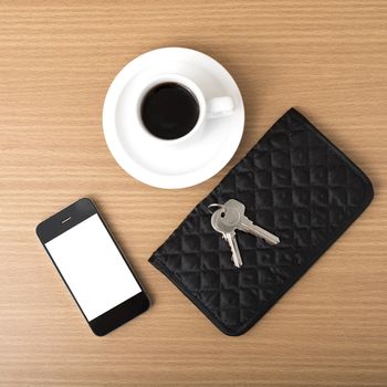 coffee phone key and wallet on wood table background