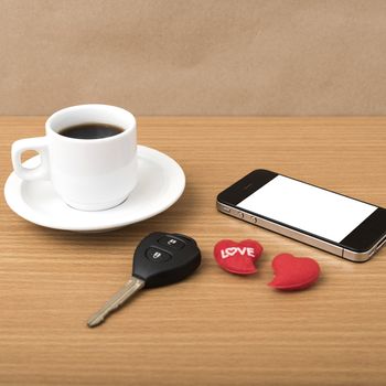 coffee phone car key and heart on wood table background