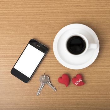 coffee phone key and heart on wood table background