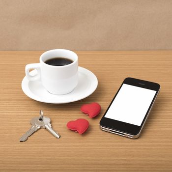 coffee phone key and heart on wood table background