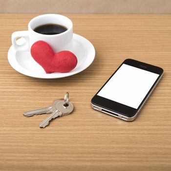 coffee phone key and heart on wood table background