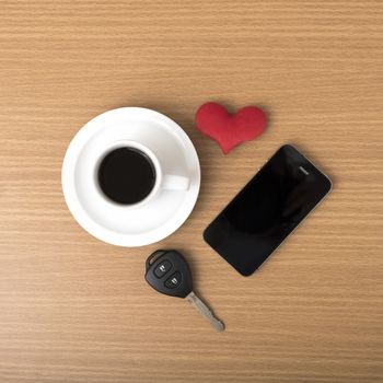coffee phone car key and heart on wood table background