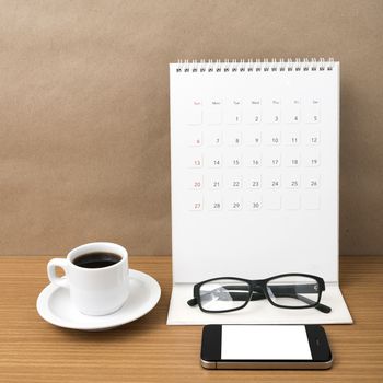 coffee,phone,eyeglasses and calendar on wood table background