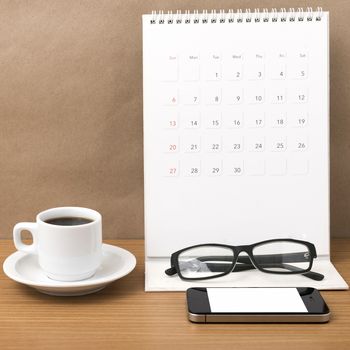 coffee,phone,eyeglasses and calendar on wood table background