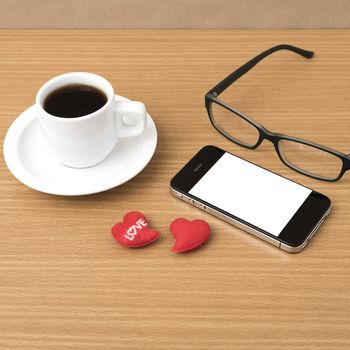 coffee,phone,eyeglasses and heart on wood table background