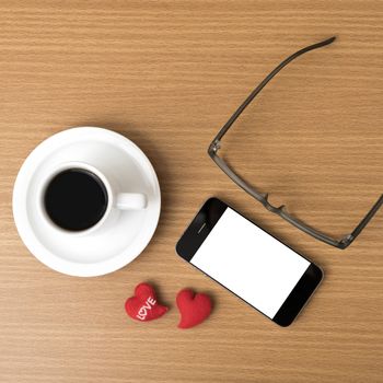 coffee,phone,eyeglasses and heart on wood table background