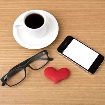 coffee,phone,eyeglasses and heart on wood table background