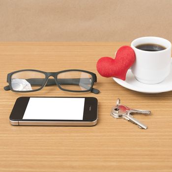 coffee,phone,eyeglasses,key and heart on wood table background