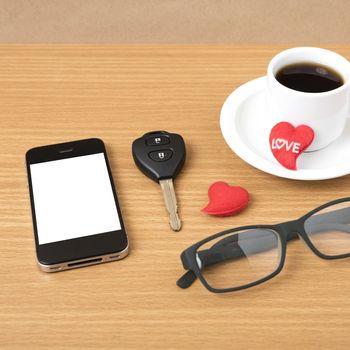 coffee,phone,eyeglasses,car key and heart on wood table background