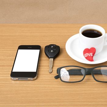 coffee,phone,eyeglasses,car key and heart on wood table background