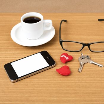 coffee,phone,eyeglasses,key and heart on wood table background