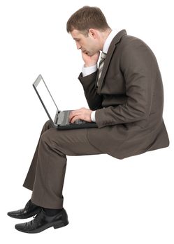 Thinking businessman working on laptop isolated on white background