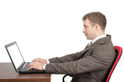 Businessman working on laptop with blank screen isolated on white background, side view