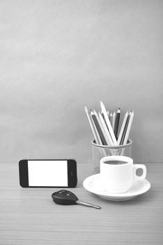 coffee,phone,car key and heart on wood table background black and white color