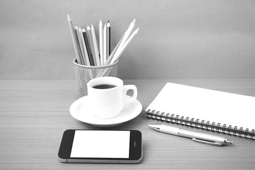 coffe,phone,notepad and color pencil on wood table background black  and white color