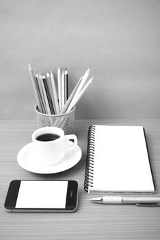 coffe,phone,notepad and color pencil on wood table background black  and white color