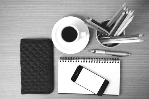 coffee,phone,eyeglasses,notepad,wallet and color pencil on wood table background  black  and white color