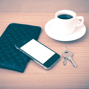 coffee phone key and wallet on wood table background vintage style