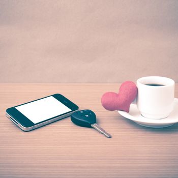 coffee phone car key and heart on wood table background vintage style