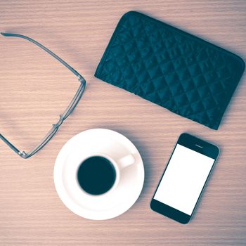 coffee,phone,eyeglasses and wallet on wood table background vintage style