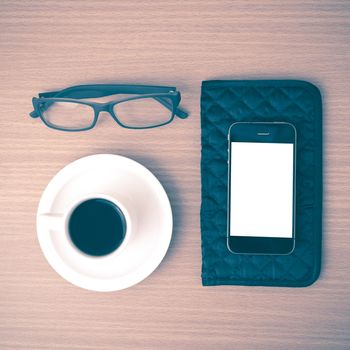 coffee,phone,eyeglasses and wallet on wood table background vintage style