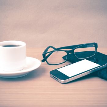 coffee,phone,eyeglasses and wallet on wood table background vintage style