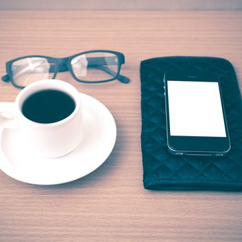 coffee,phone,eyeglasses and wallet on wood table background vintage style