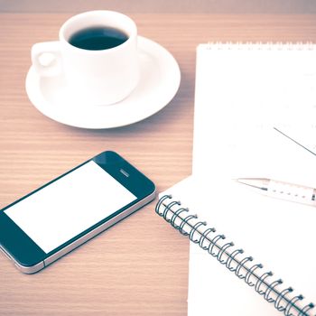 coffee,phone,notepad and calendar on wood table background vintage style