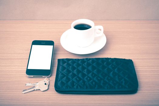 coffee phone key and wallet on wood table background vintage style