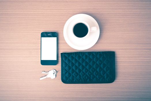 coffee phone key and wallet on wood table background vintage style