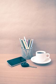 coffee,phone,car key and heart on wood table background vintage style