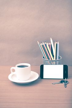 coffee,phone,key and pencil on wood table background vintage style