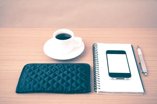 coffee,phone,notepad and wallet on wood table background vintage style