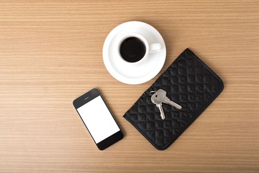 coffee phone key and wallet on wood table background