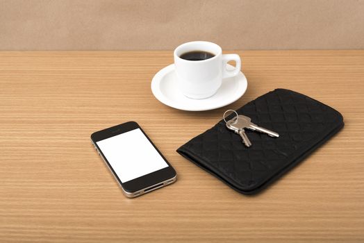coffee phone key and wallet on wood table background