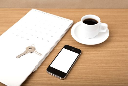 coffee,phone,key and calendar on wood table background