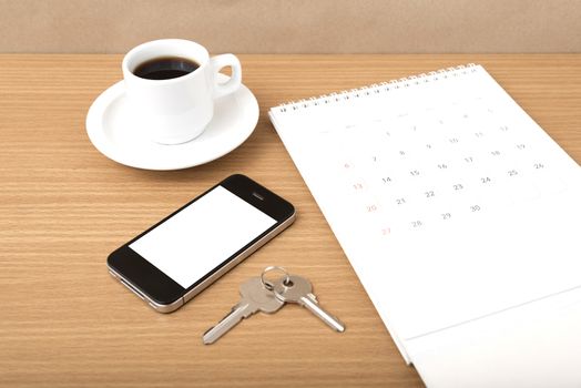 coffee,phone,key and calendar on wood table background