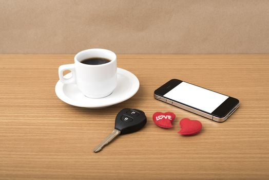 coffee phone car key and heart on wood table background