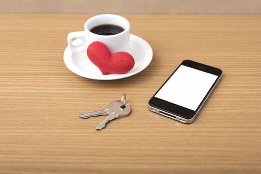 coffee phone key and heart on wood table background