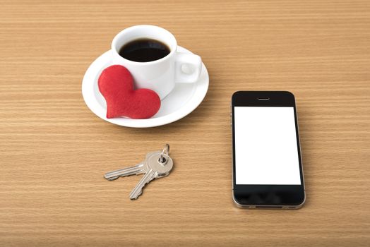 coffee phone key and heart on wood table background