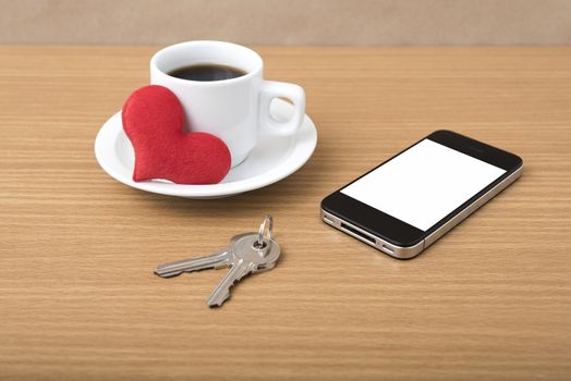 coffee phone key and heart on wood table background